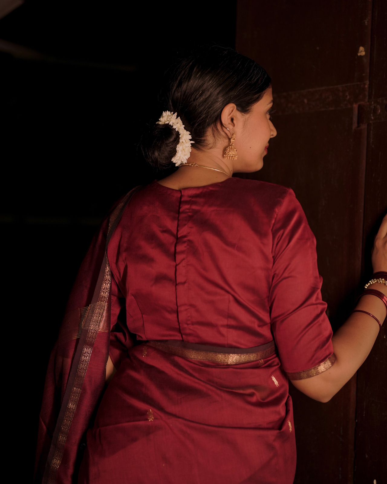 Deep maroon Maheshwari saree with flower bootis all over
