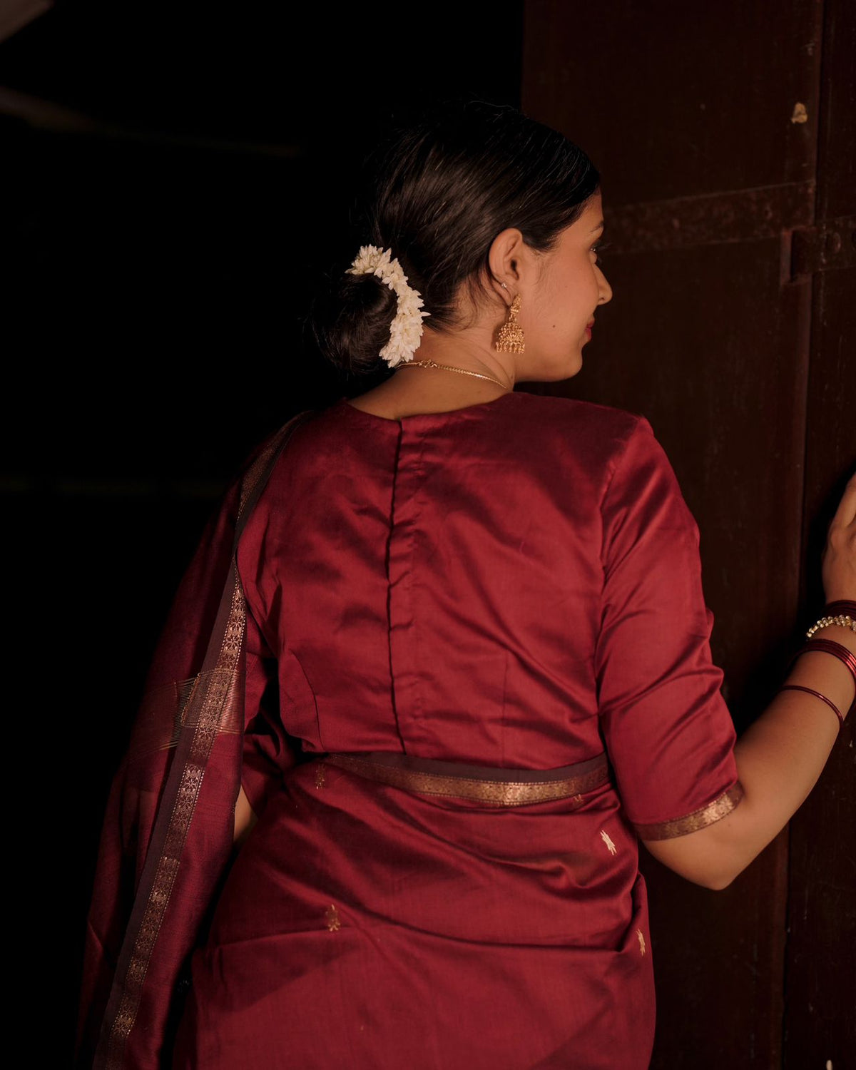 Deep maroon Maheshwari saree with flower bootis all over